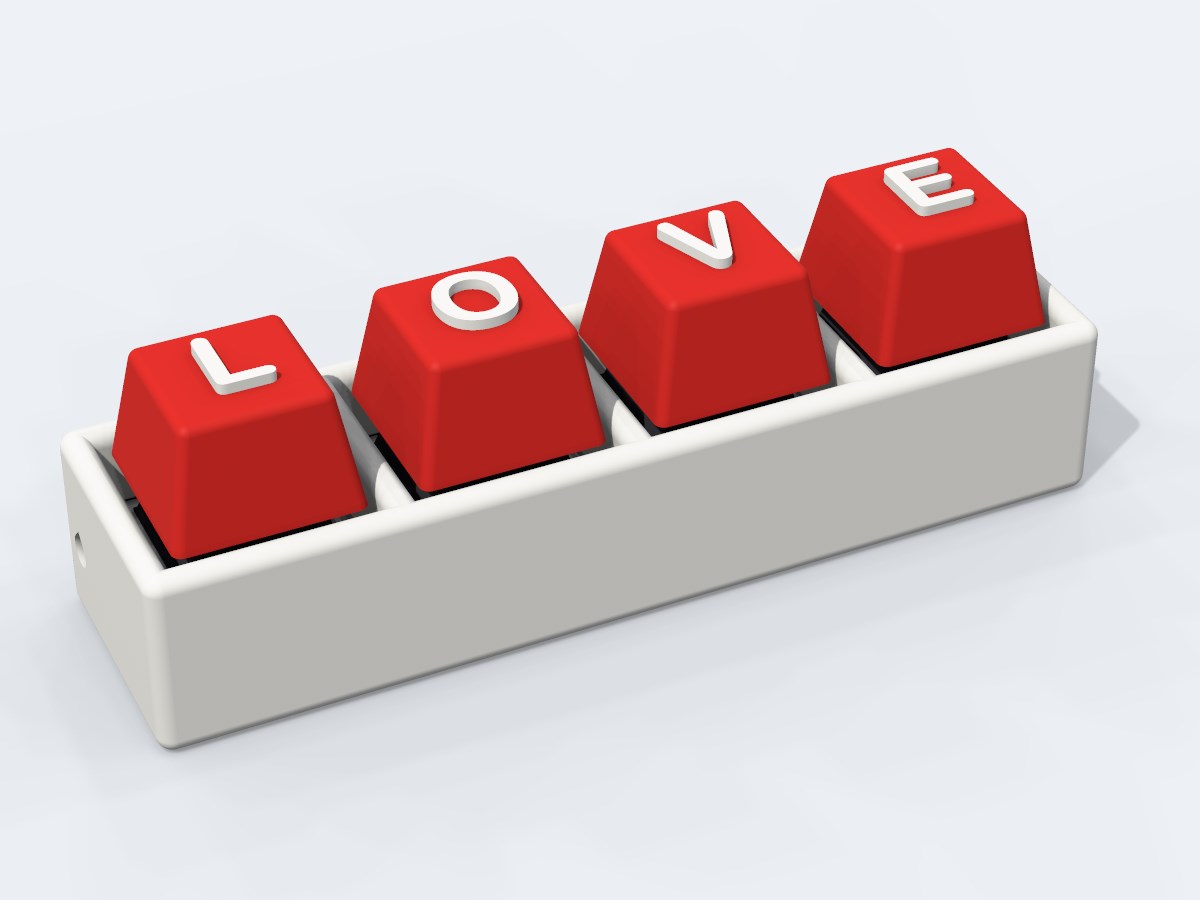 Quad clicker, white body, red caps spelling LOVE in white