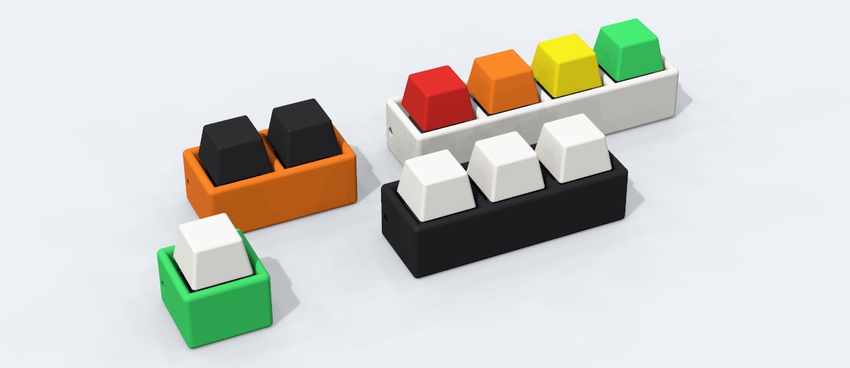 Four plain clickers in light green, orange, black and white, from 1 key to 4 keys